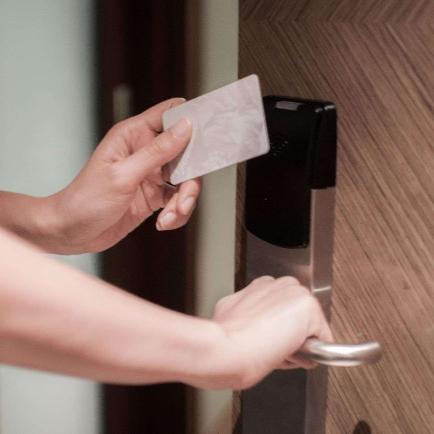 GettyImages-1141450056-b7c5d36c Person using keycard to unlock door.