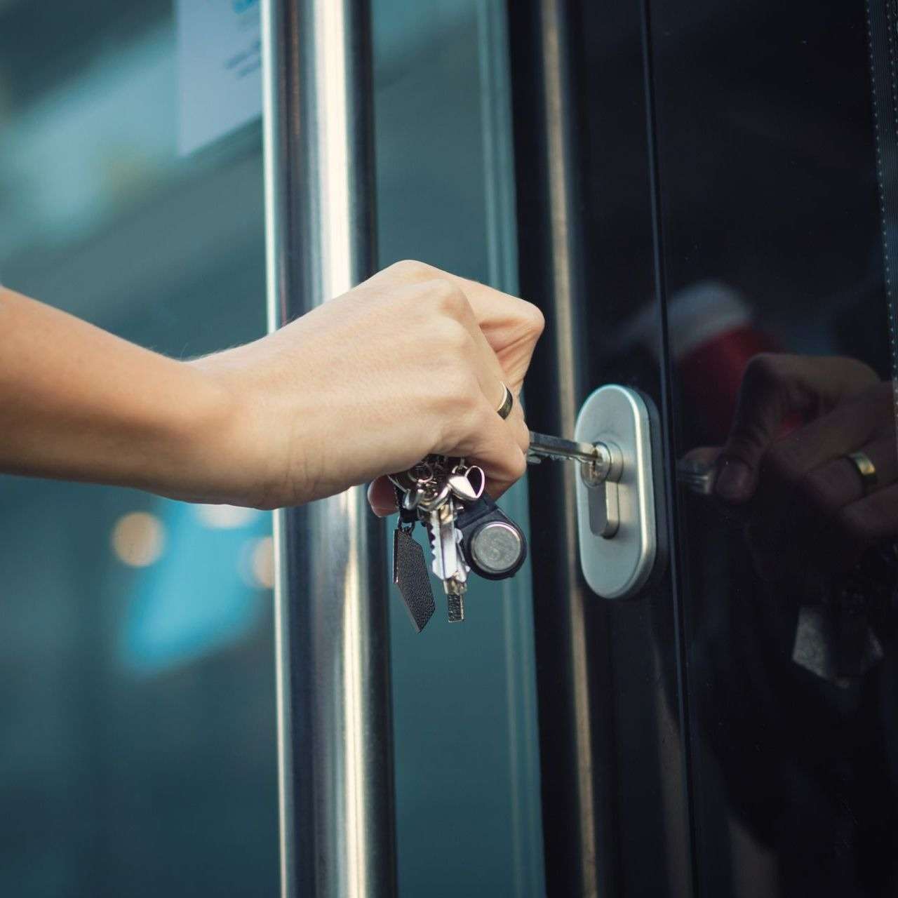 GettyImages-882354884-15435481-1 Person unlocking a door with keys.